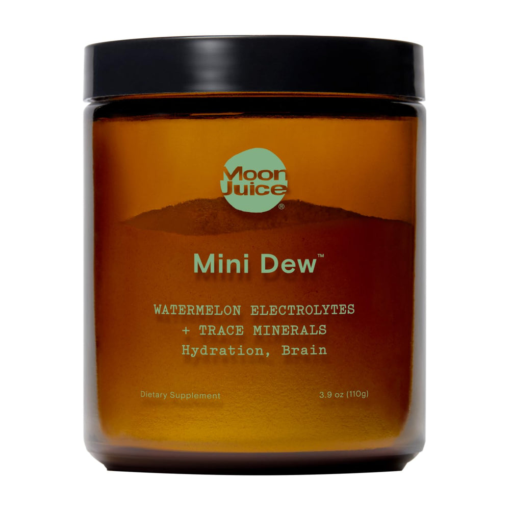 Moon Juice Mini Dew electrolytes powder being poured from the bottle for quick hydration