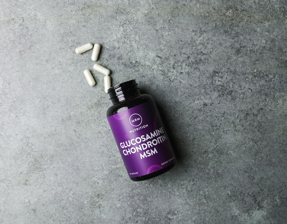 MRM capsules near yoga mat illustrating flexibility and comfort.