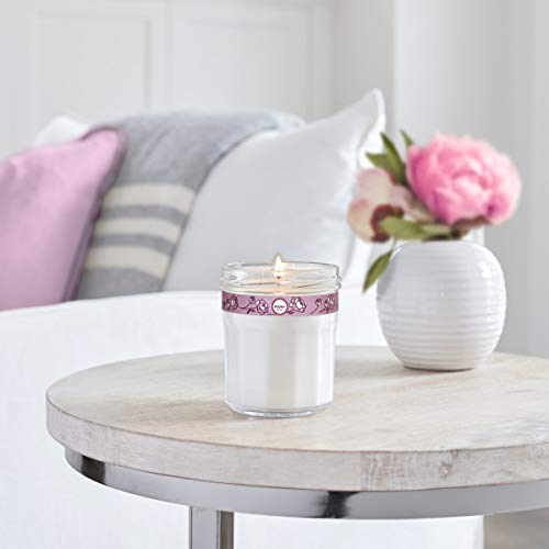 Candle in recyclable glass jar showcases eco-friendly packaging.