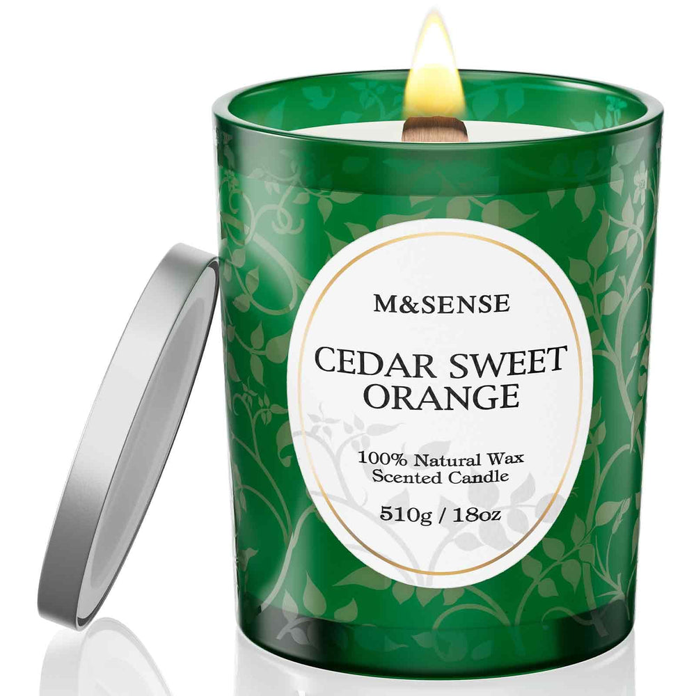 M&SENSE Cedarwood Orange candle jar close-up with warm amber glow.