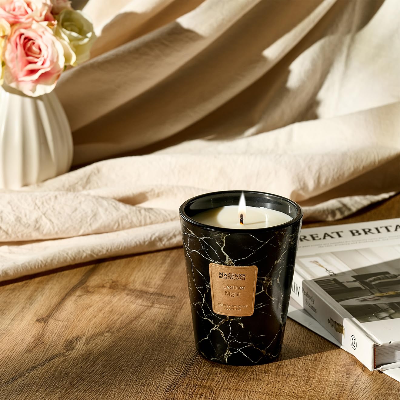 M&SENSE candle glows warmly in a living room setting for ambiance