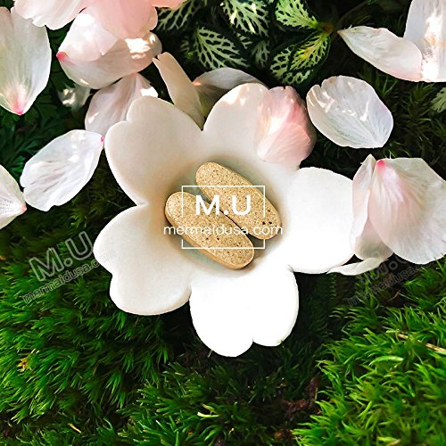 Close-up of M.U Magic Whitening Pills showing capsules for nourished skin.