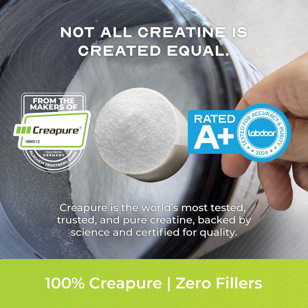 Muscle Feast Creapure scoop beside powder for easy mixing.
