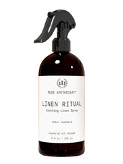 Muse Apothecary Linen Ritual bottle pour showcasing amber cashmere scent for soothing fabrics