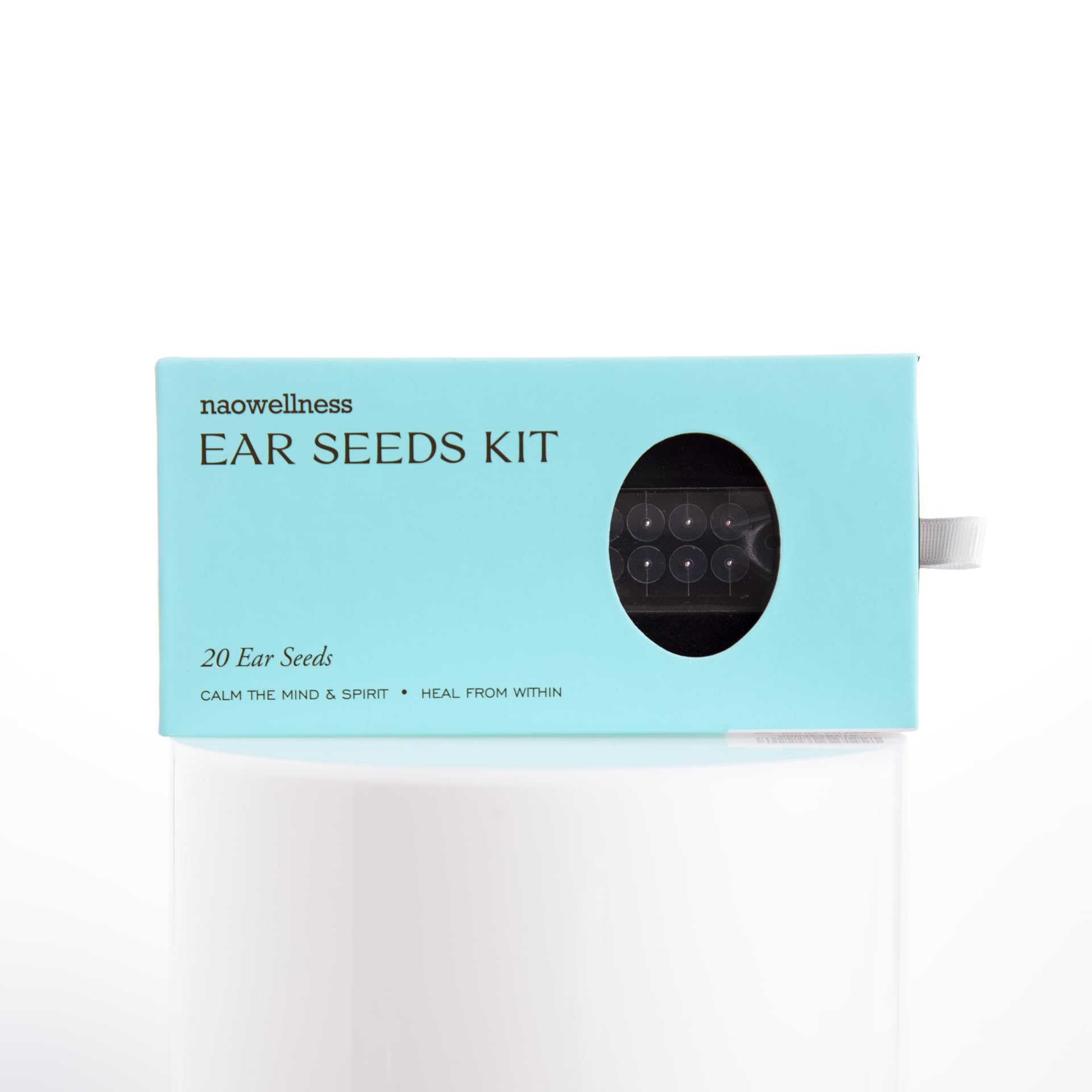 Close-up of NAO Wellness steel ear seeds showing durable, needle-free design.