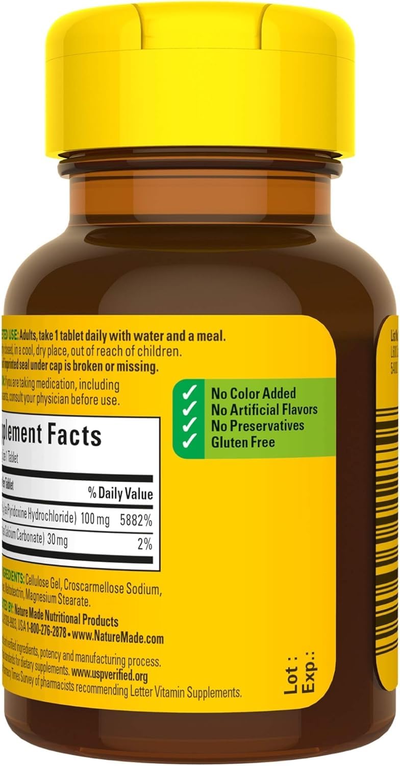 Nature Made B6 100 mg tablets arranged with a glass of water for convenience.