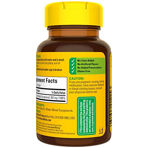 Nature Made Vitamin E softgels on nightstand during routine