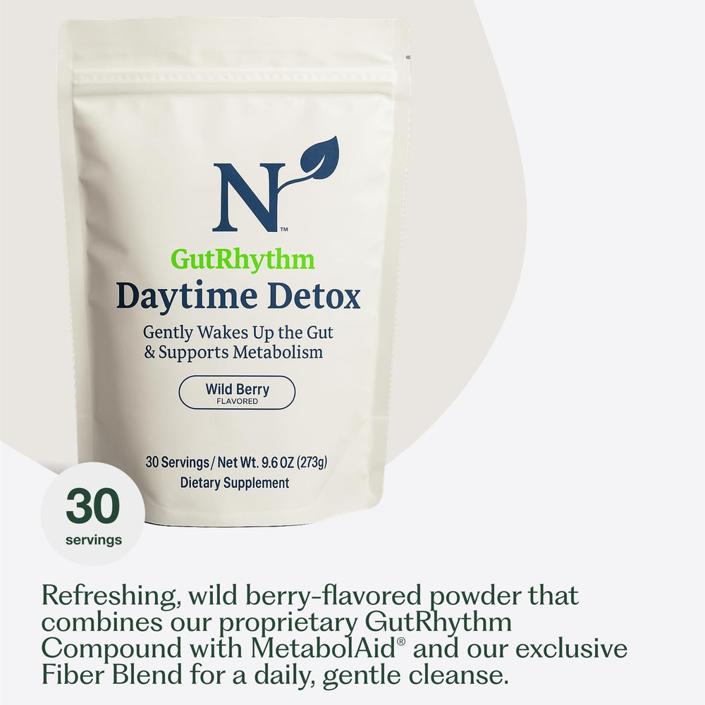 Nature M.D. GutRhythm daily scoop beside a glass ready for daily use.