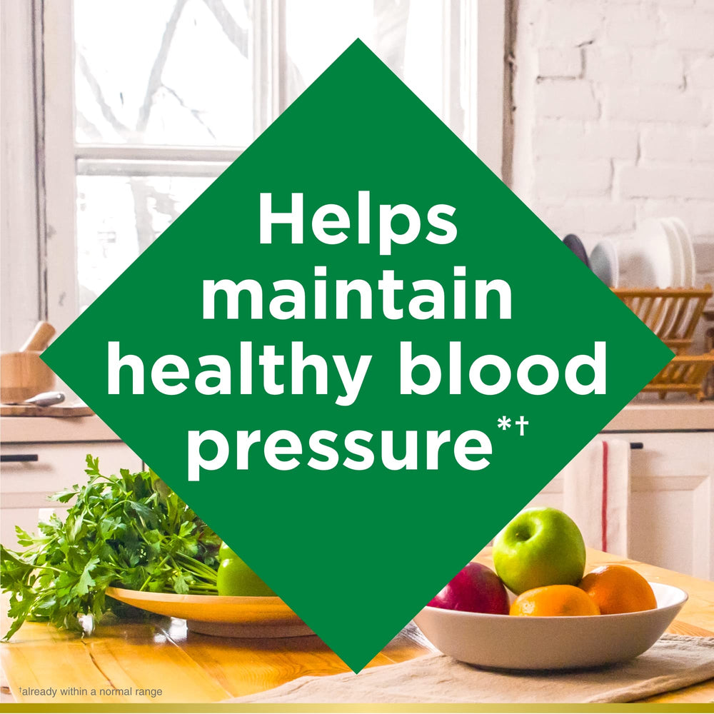 Nature's Bounty CoQ10 bottle beside a glass suggesting daily use for energy support.
