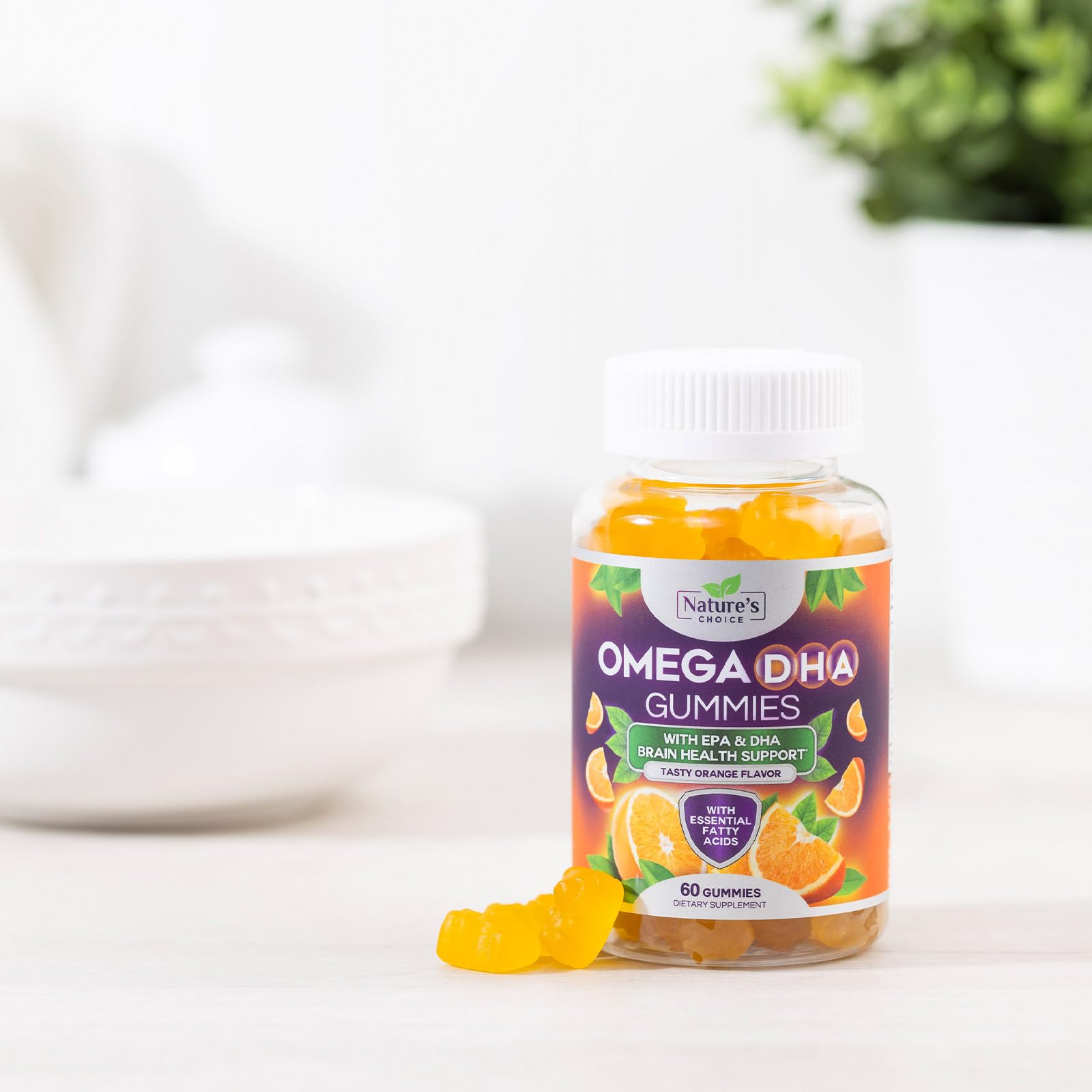 Orange gummy pieces next to a glass of water for Nature's Choice Omega 3 Gummies.
