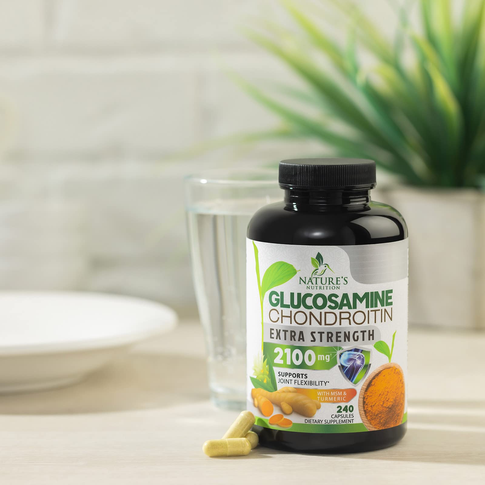 Nature's Nutrition bottle in hand on kitchen counter
