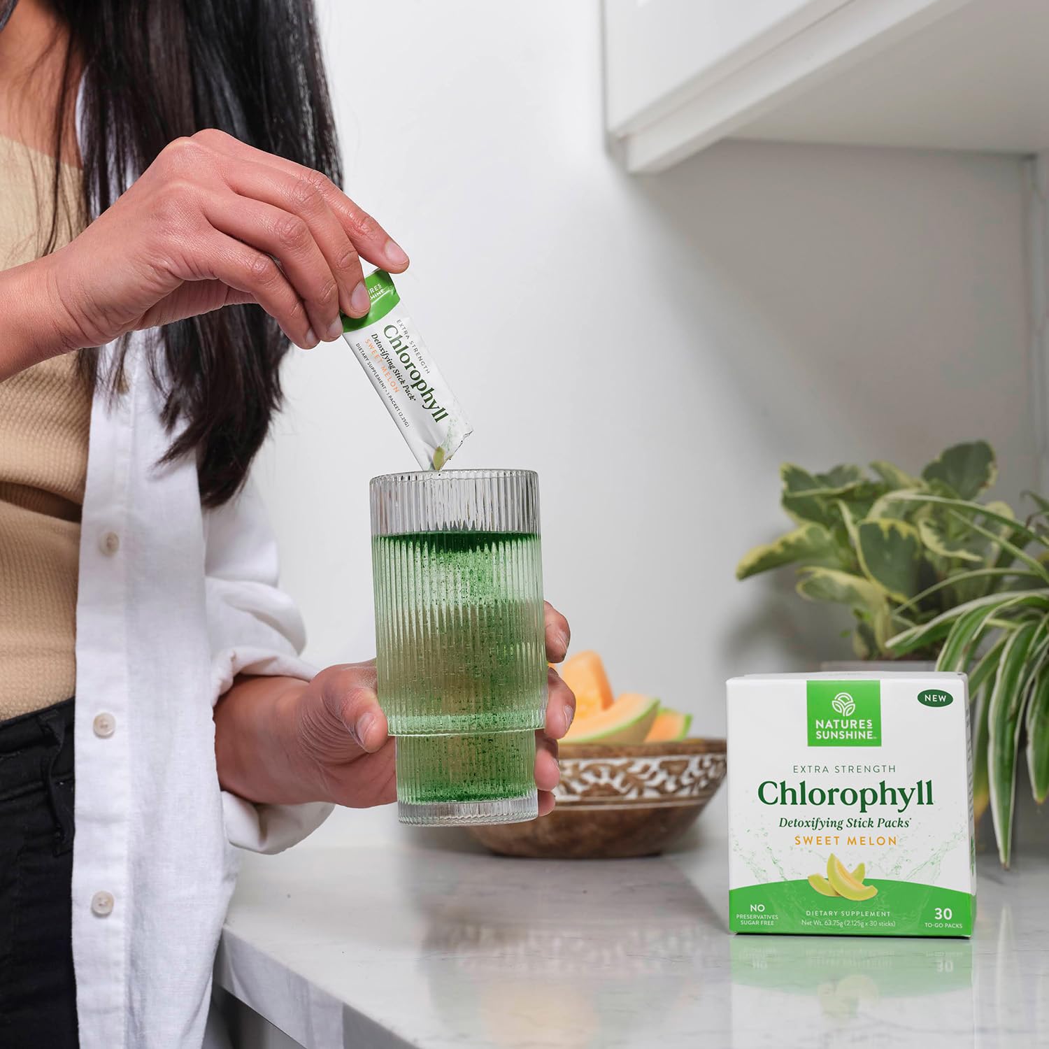 Chlorophyll Stick Pack Melon being poured into a glass showing vibrant color.