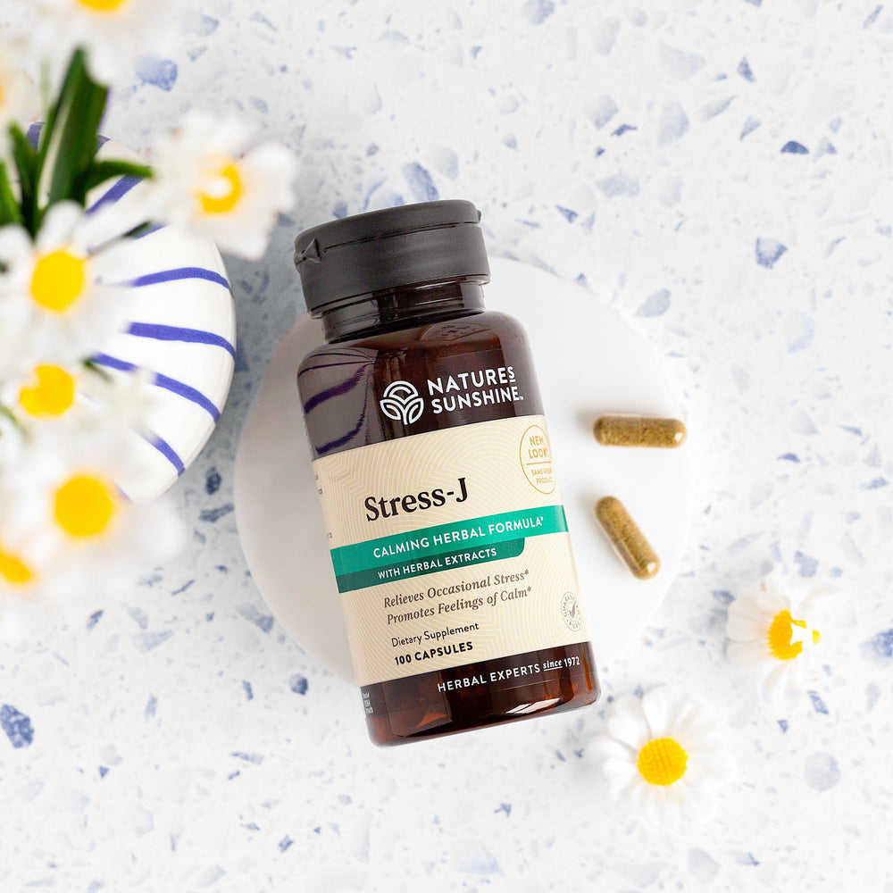 Nature's Sunshine Stress-J capsules on a table for daily use