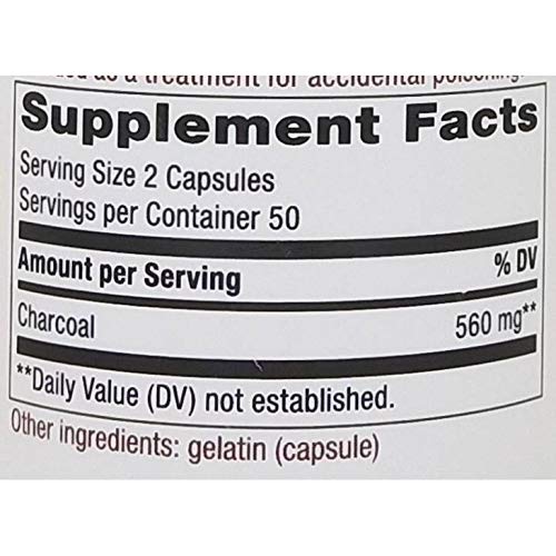 Nature's Way Activated Charcoal Hi Po bottle beside glass to illustrate daily use setting