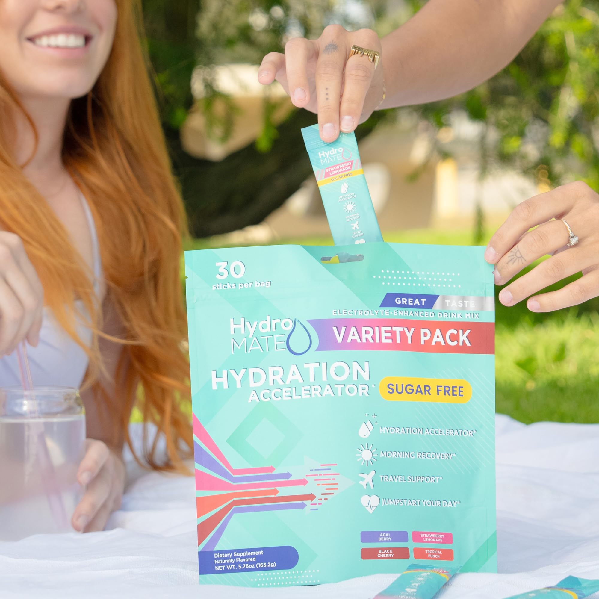 NatureWorks HydroMATE travel-ready packets beside a gym bag for workouts.