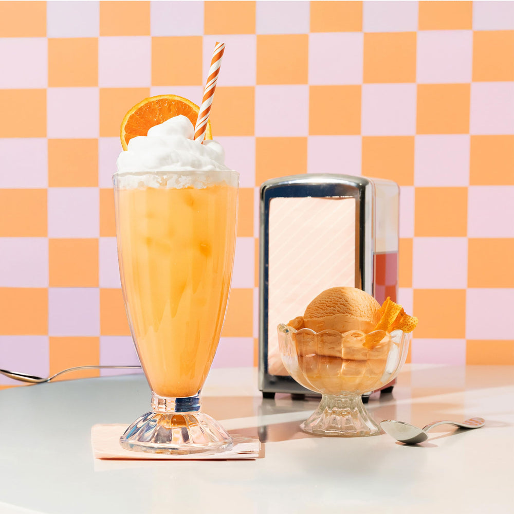 Nello orange creamsicle powder scoop ready for a flavorful daily ritual.