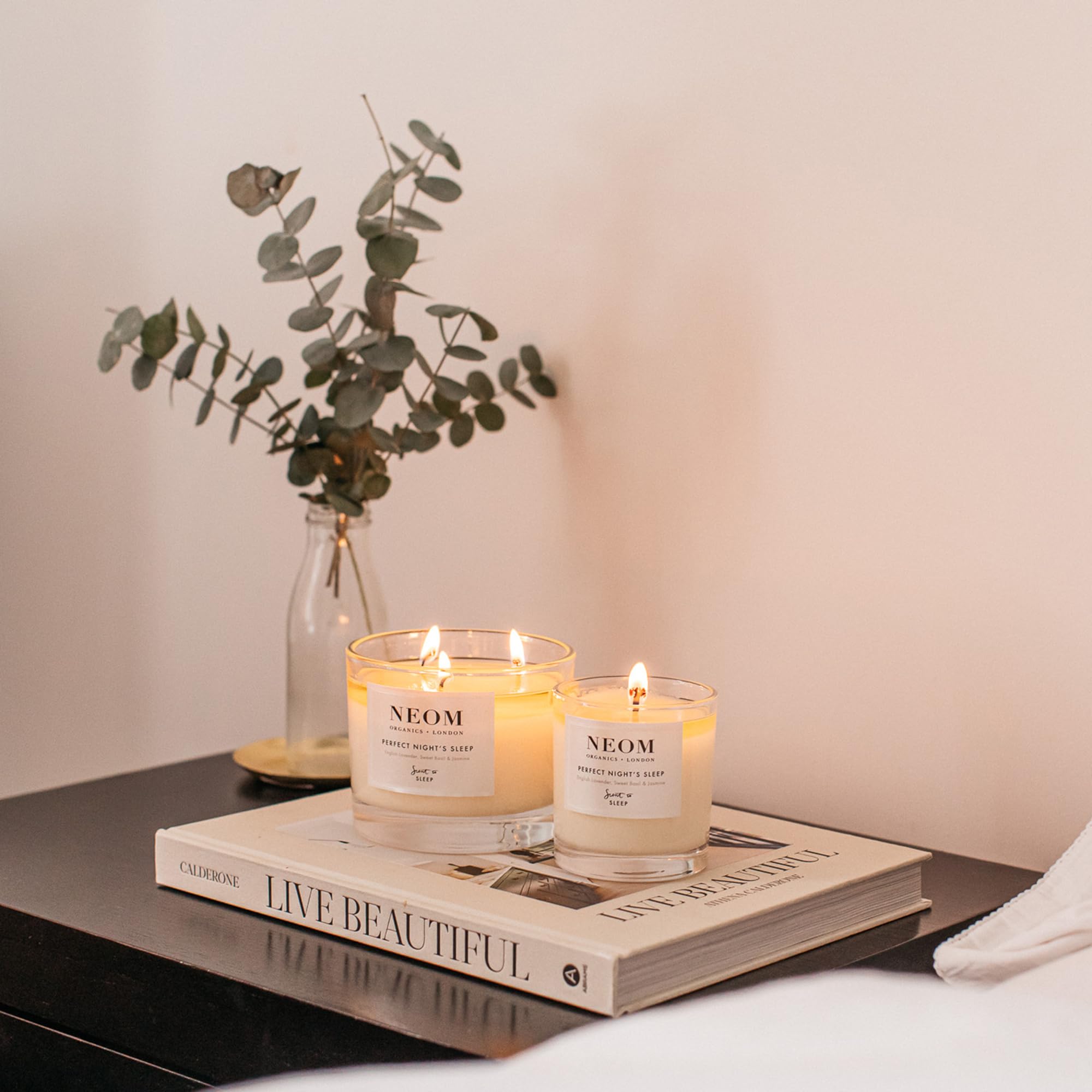Candle on a coffee table with flowers for relaxing ambience