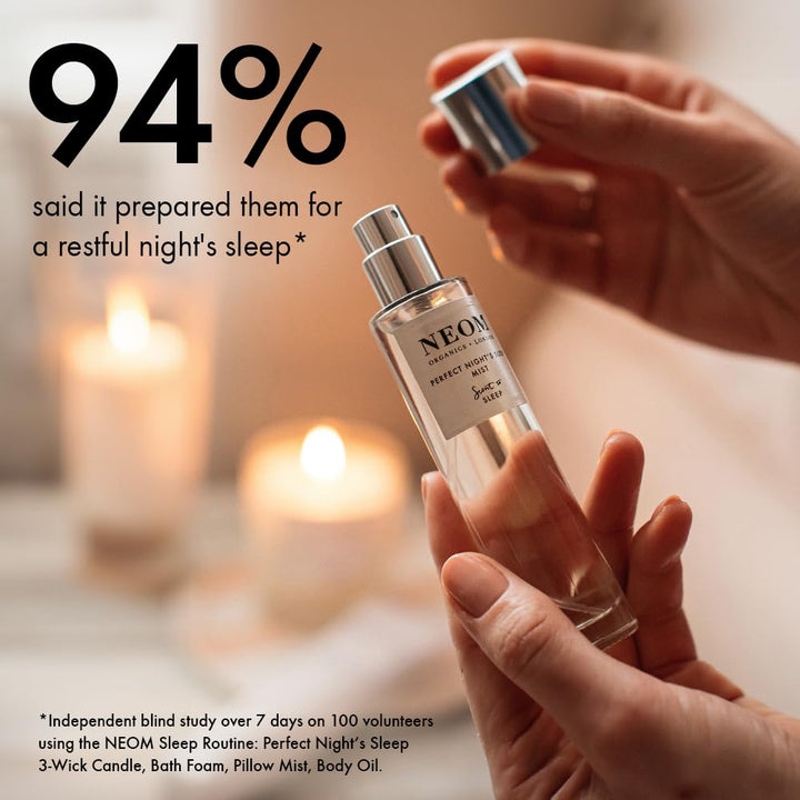 Neom Perfect Night's Sleep Mist room diffusion with candle enhances relaxing atmosphere.