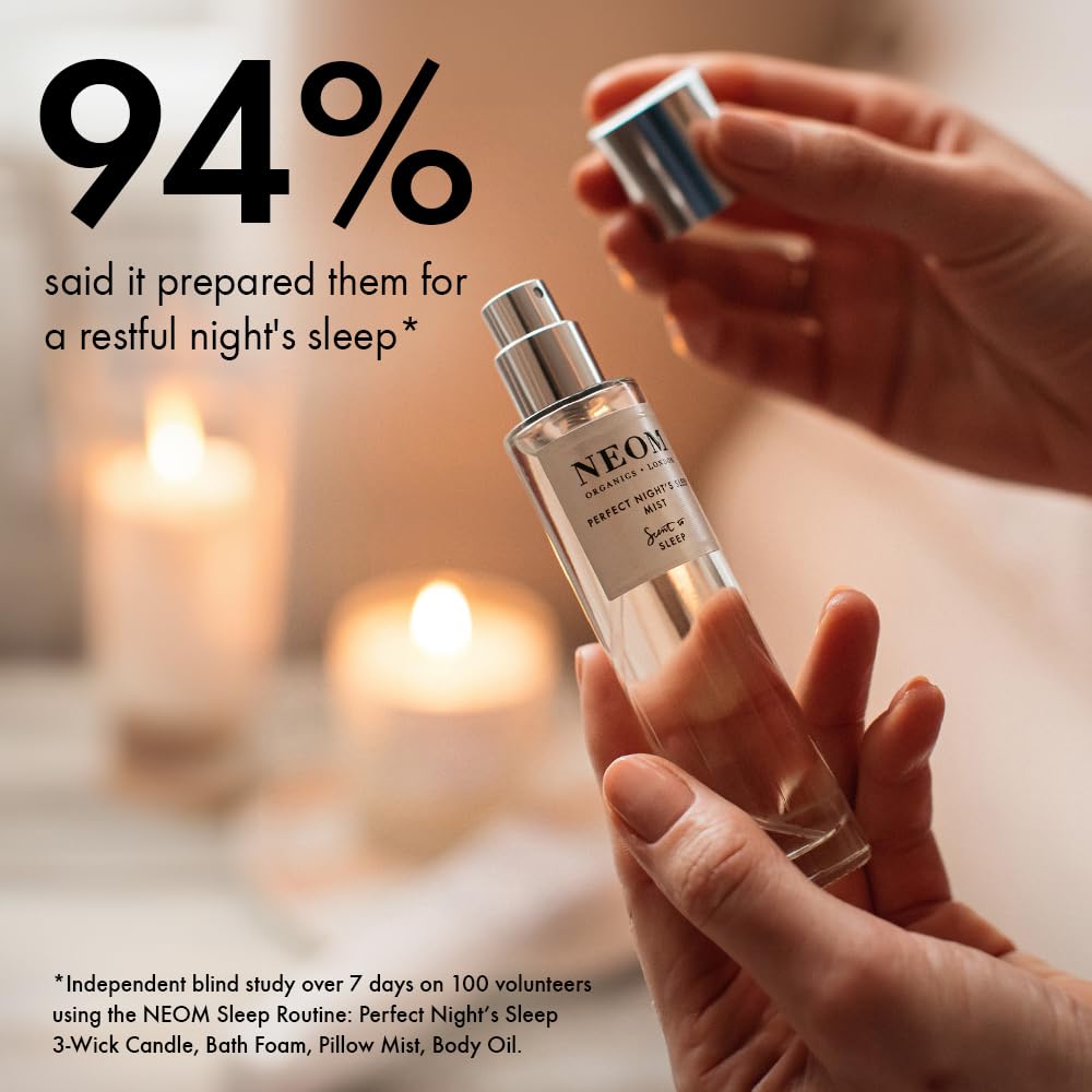 Neom Perfect Night's Sleep Mist room diffusion with candle enhances relaxing atmosphere.
