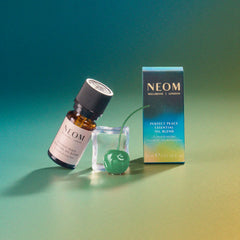 NEOM Perfect Peace bath drops creating serene soaking experience.