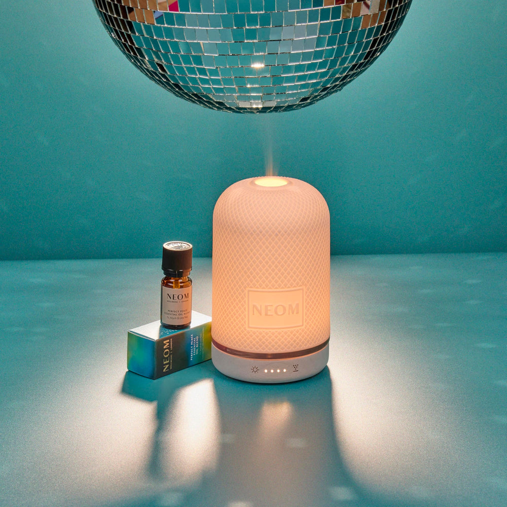 NEOM Perfect Peace Wellbeing Pod diffuses uplifting fragrance throughout a room.