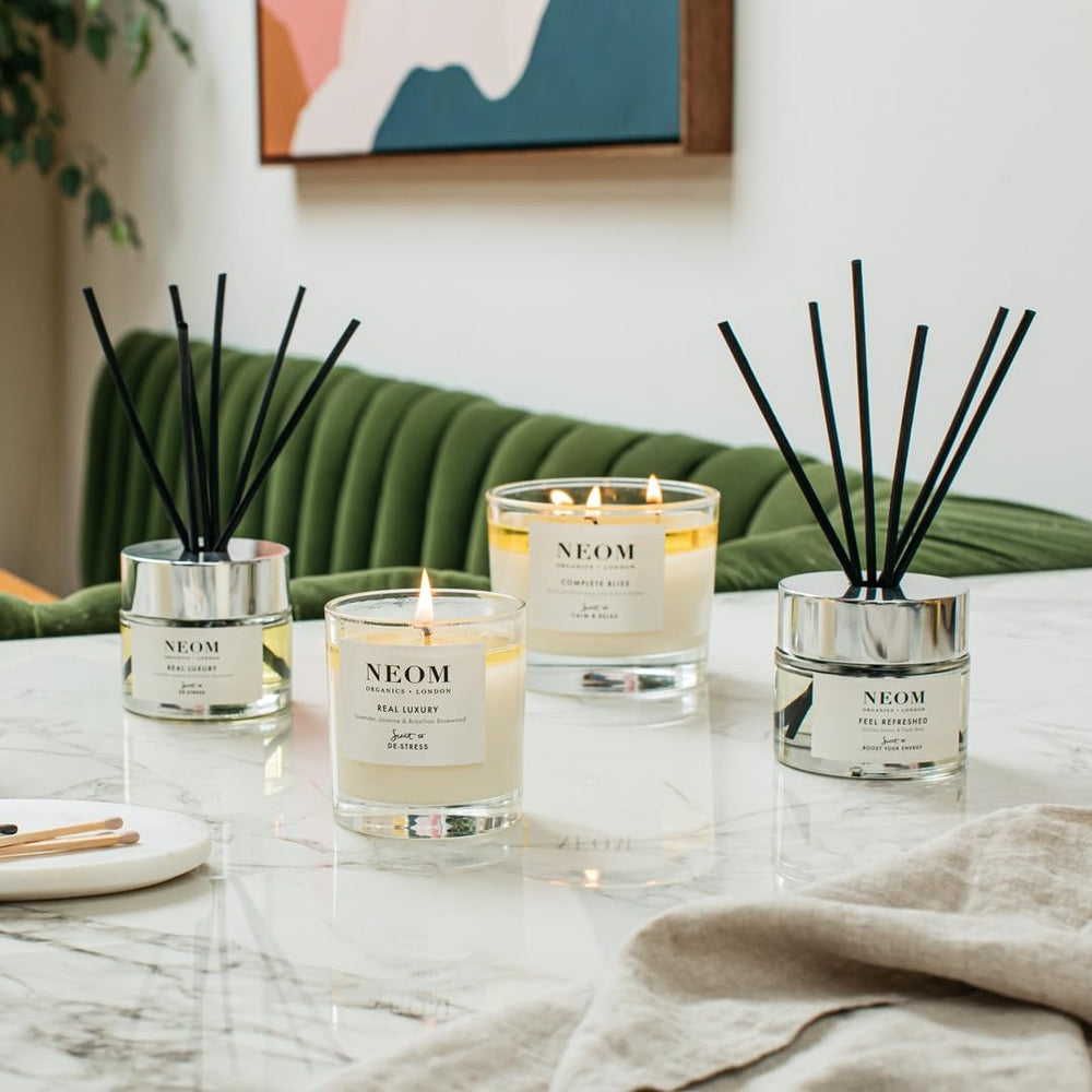 Close-up NEOM Real Luxury Candle jar with elegant branding