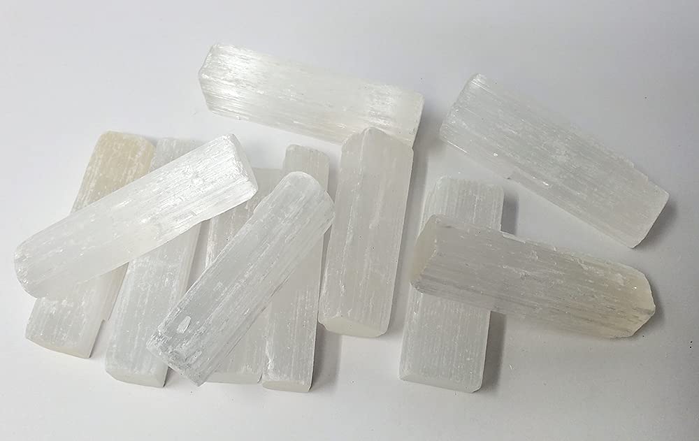 New Age Imports selenite sticks 2-3in for meditation and energy cleansing.