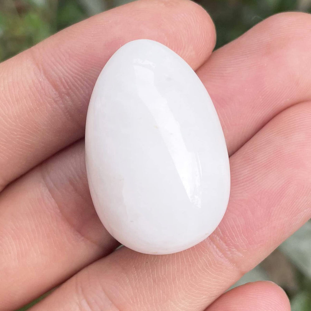 Neyisaa hand-carved stone egg, palm-size and decorative.