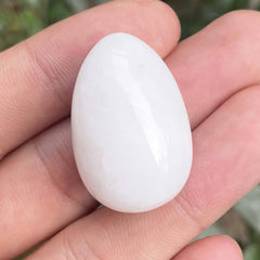 Neyisaa hand-carved stone egg, palm-size and decorative.