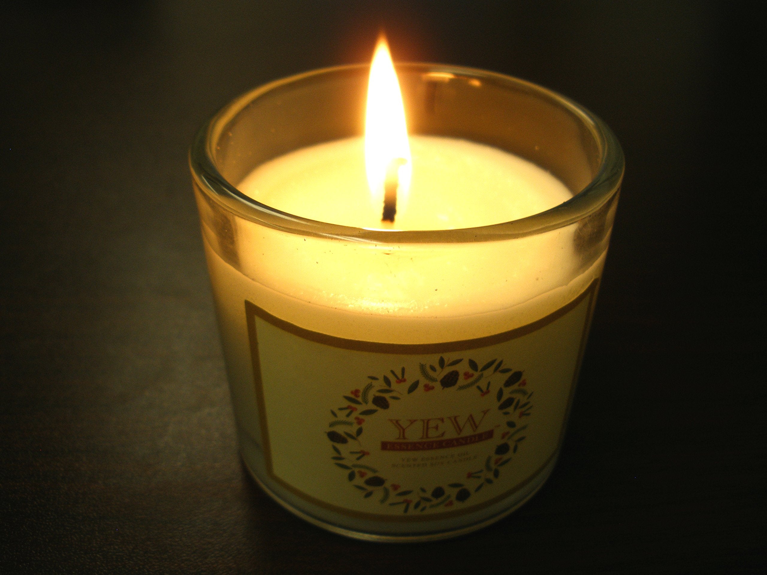 NINSAR Yew Essence Candle lit scene evokes calming aroma.