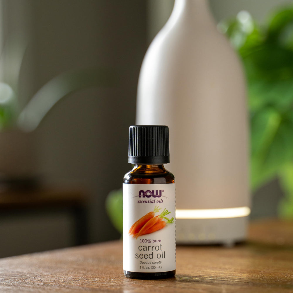 NOW Foods carrot seed oil label on bottle signaling vegan, cruelty-free origins
