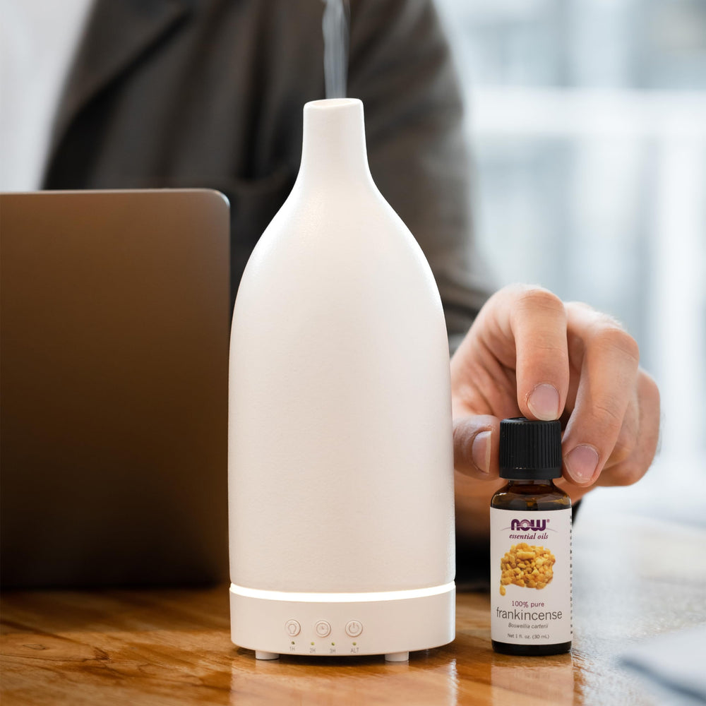 NOW Foods Frankincense Oil drops on cotton pad illustrate aroma diffusion.