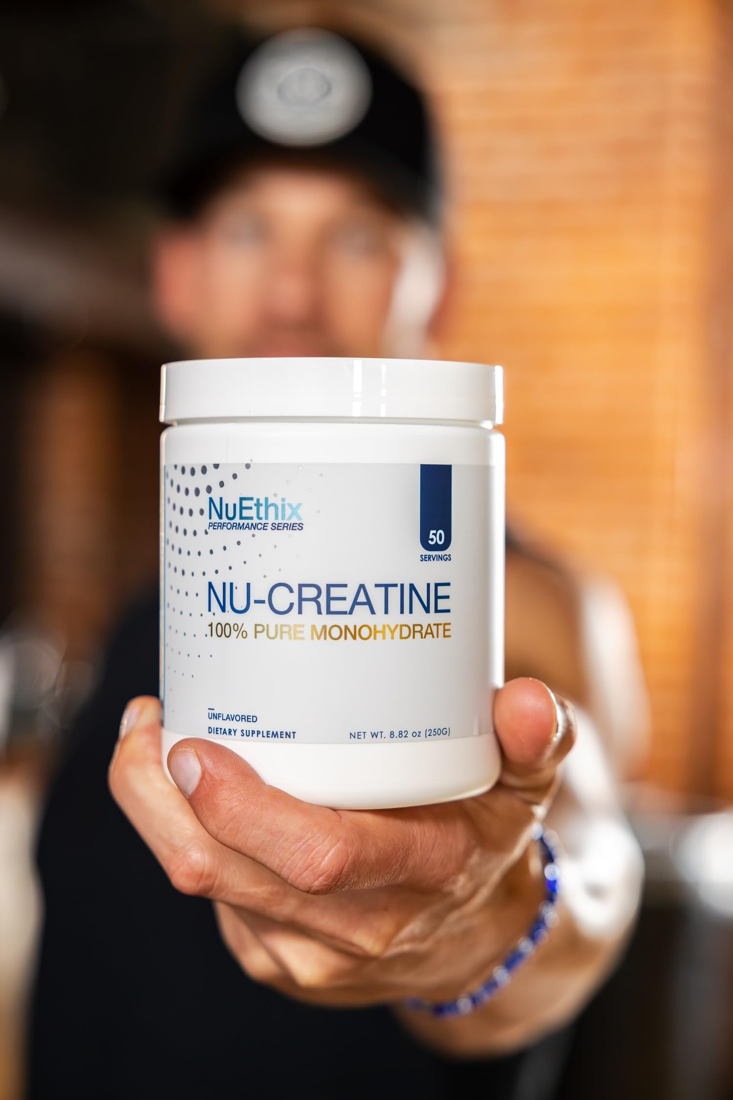 NuEthix Nu-Creatine Pure Monohydrate powder with glass and water suggests post-workout use.