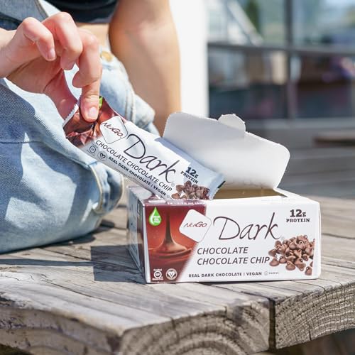Close-up of NuGo Dark Chocolate Chip bar dipped in dark chocolate for rich flavor.