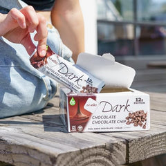 Close-up of NuGo Dark Chocolate Chip bar dipped in dark chocolate for rich flavor.