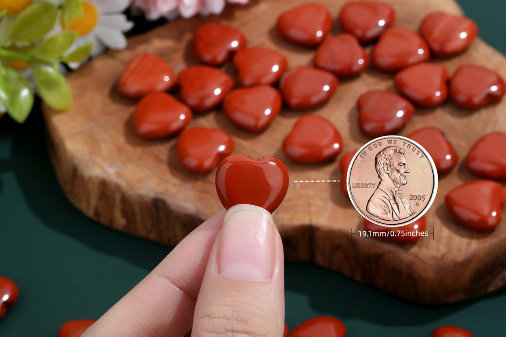 NUKAYAI hand-holding red jasper crystal, showcasing grounding energy in use.