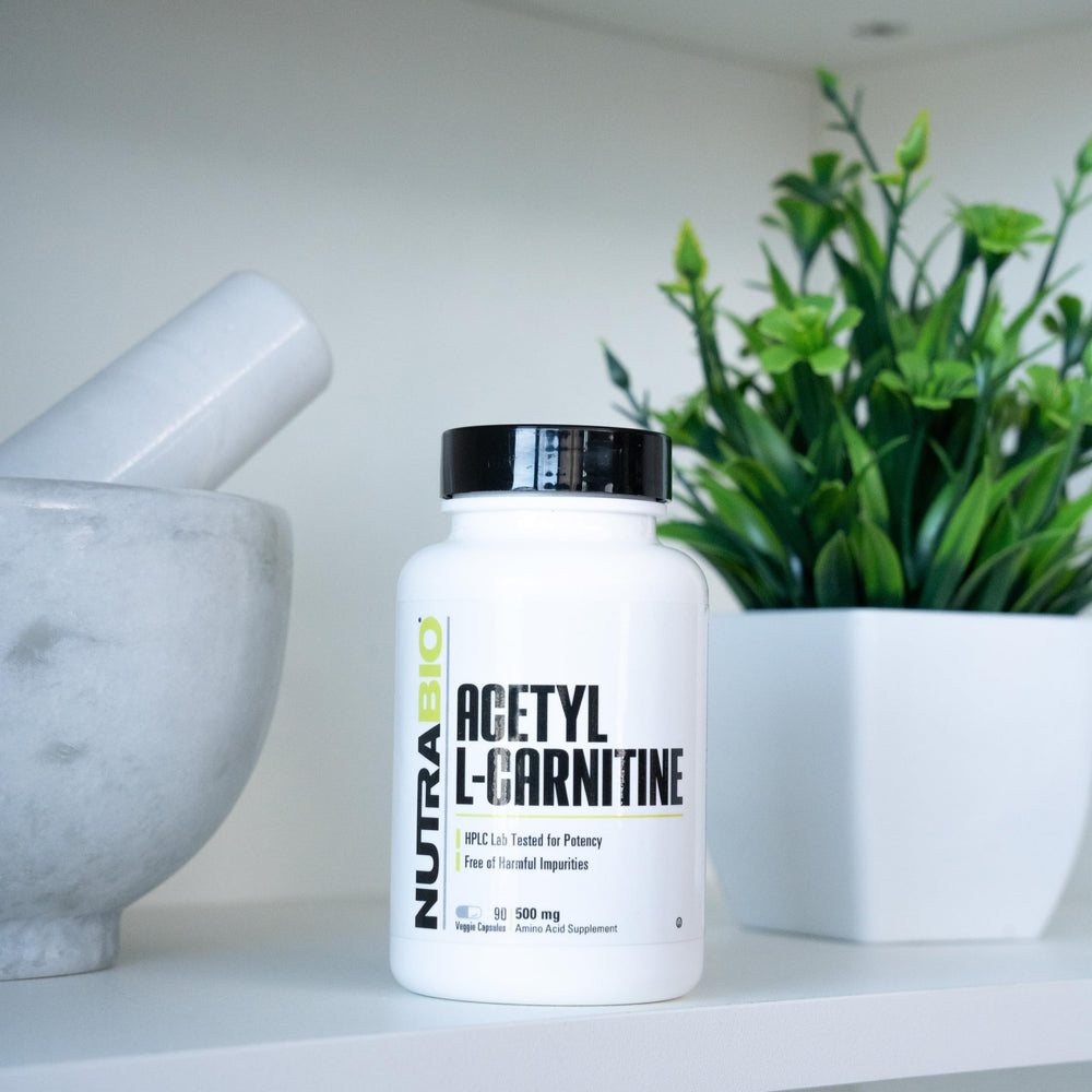 NutraBio Acetyl L-Carnitine capsules closeup for daily energy and focus.