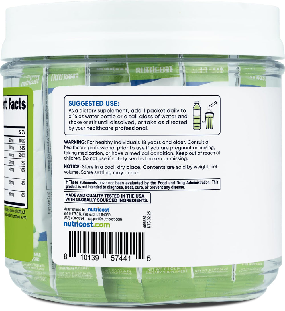 Dissolving Nutricost Electrolytes Green Apple stickpack in a glass of water.
