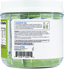 Dissolving Nutricost Electrolytes Green Apple stickpack in a glass of water.
