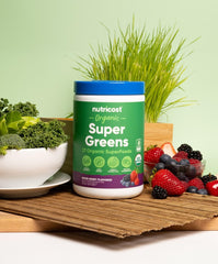 Nutricost Organic Super Greens jar on kitchen counter ready for shakes