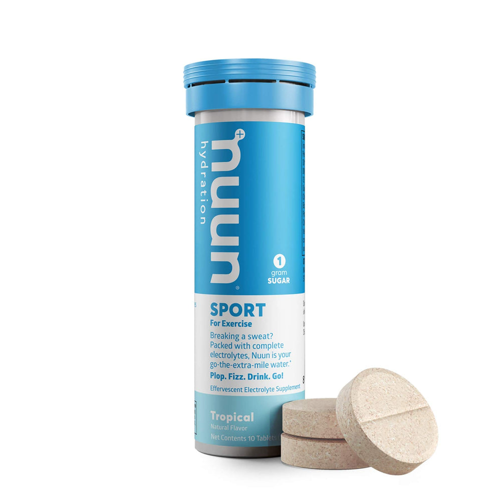 Dissolving Nuun Active Tropical Fruit tab in water for flavorful hydration.