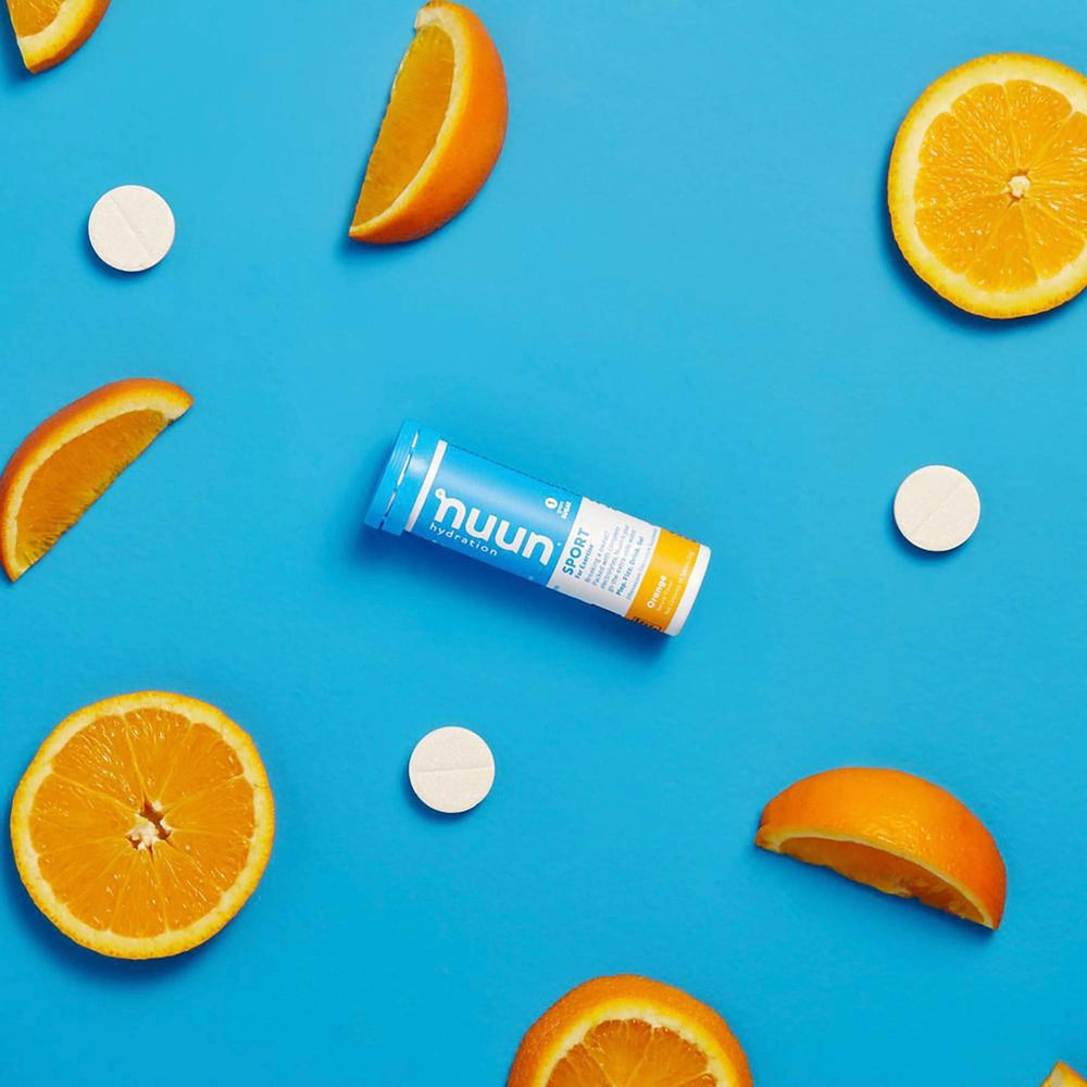 Nuun Sport Orange tablets dissolving in water to create a refreshing orange drink.