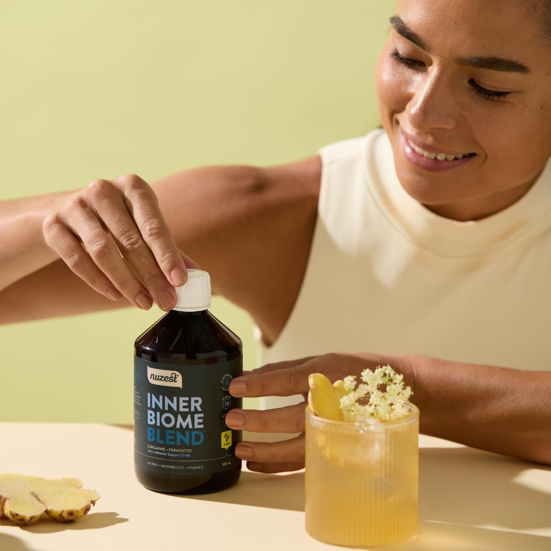 Nuzest Inner Biome Blend measuring scoop suggesting easy daily dosing.