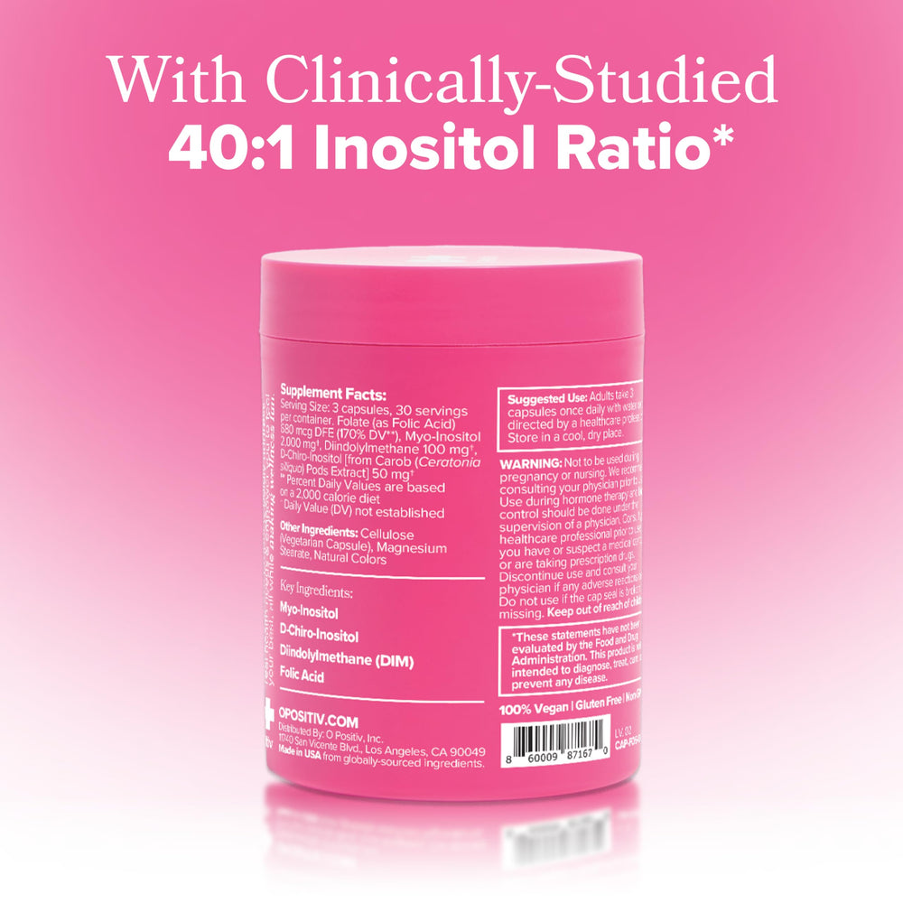 O Positiv FLO glass with water and capsules for daily routine use.