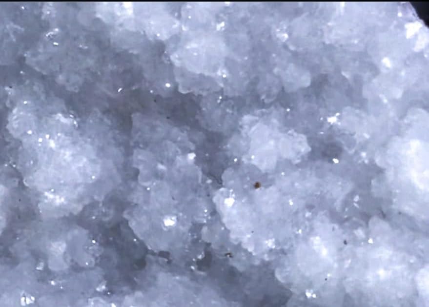 Okenite Druzy Crystal Cluster in a peaceful setup suggests space for spiritual practice.