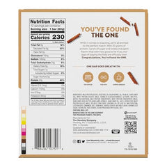 ONE Cinnamon Roll Bar unwrapped beside gym gear, inviting aroma.