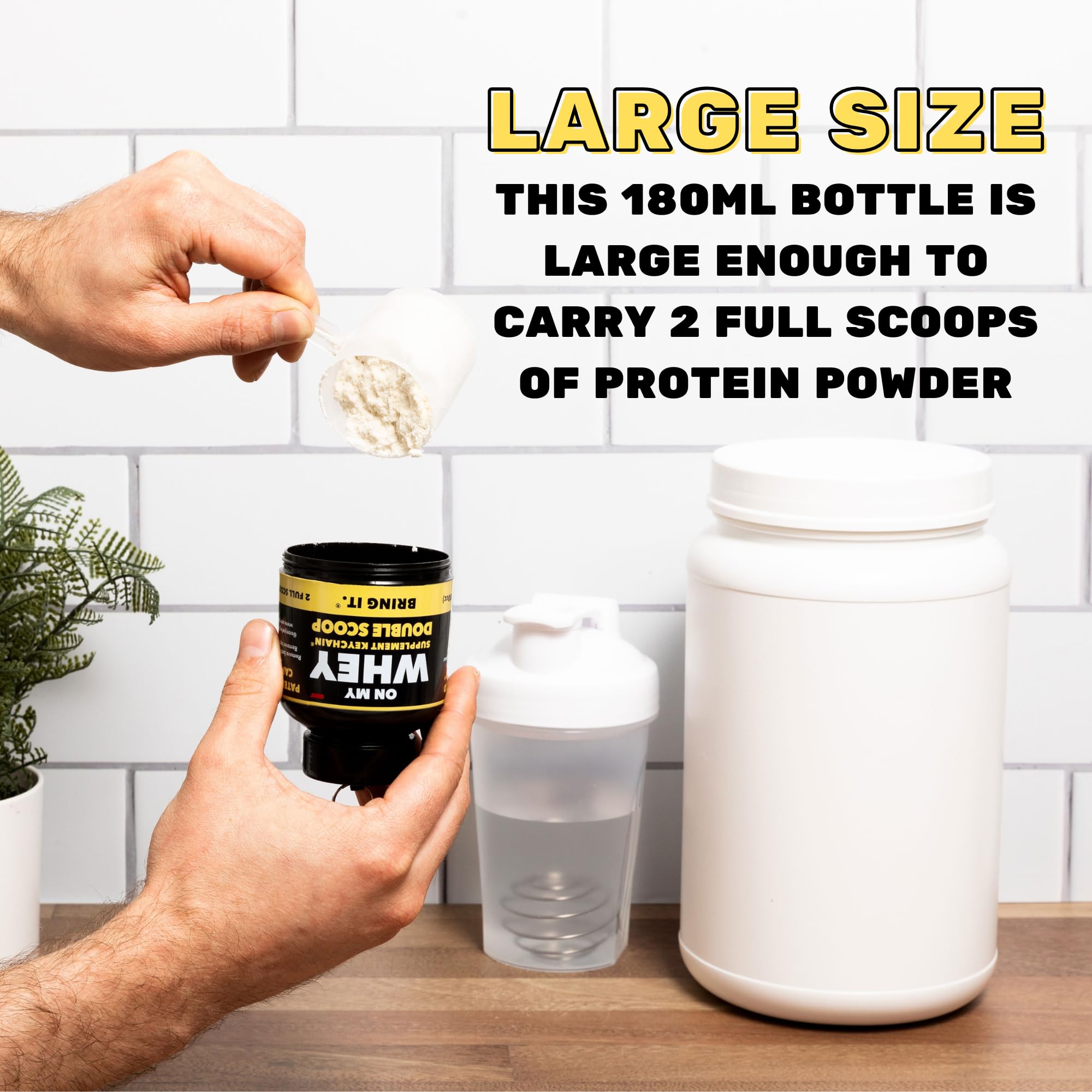 OnMyWhey mini supplement keychain container clipped to bag.