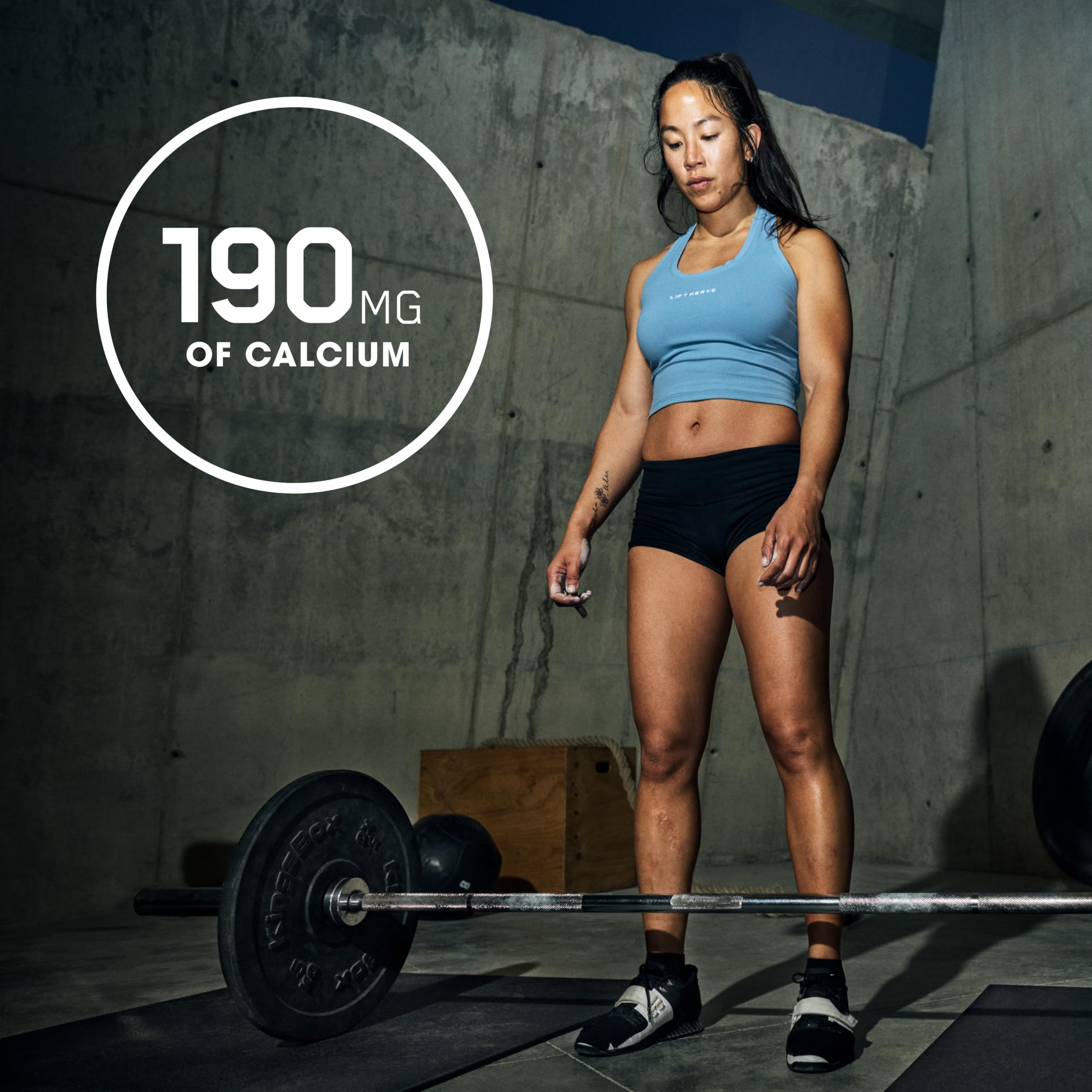 Optimum Nutrition Opti-Women capsules beside a glass of water after a workout