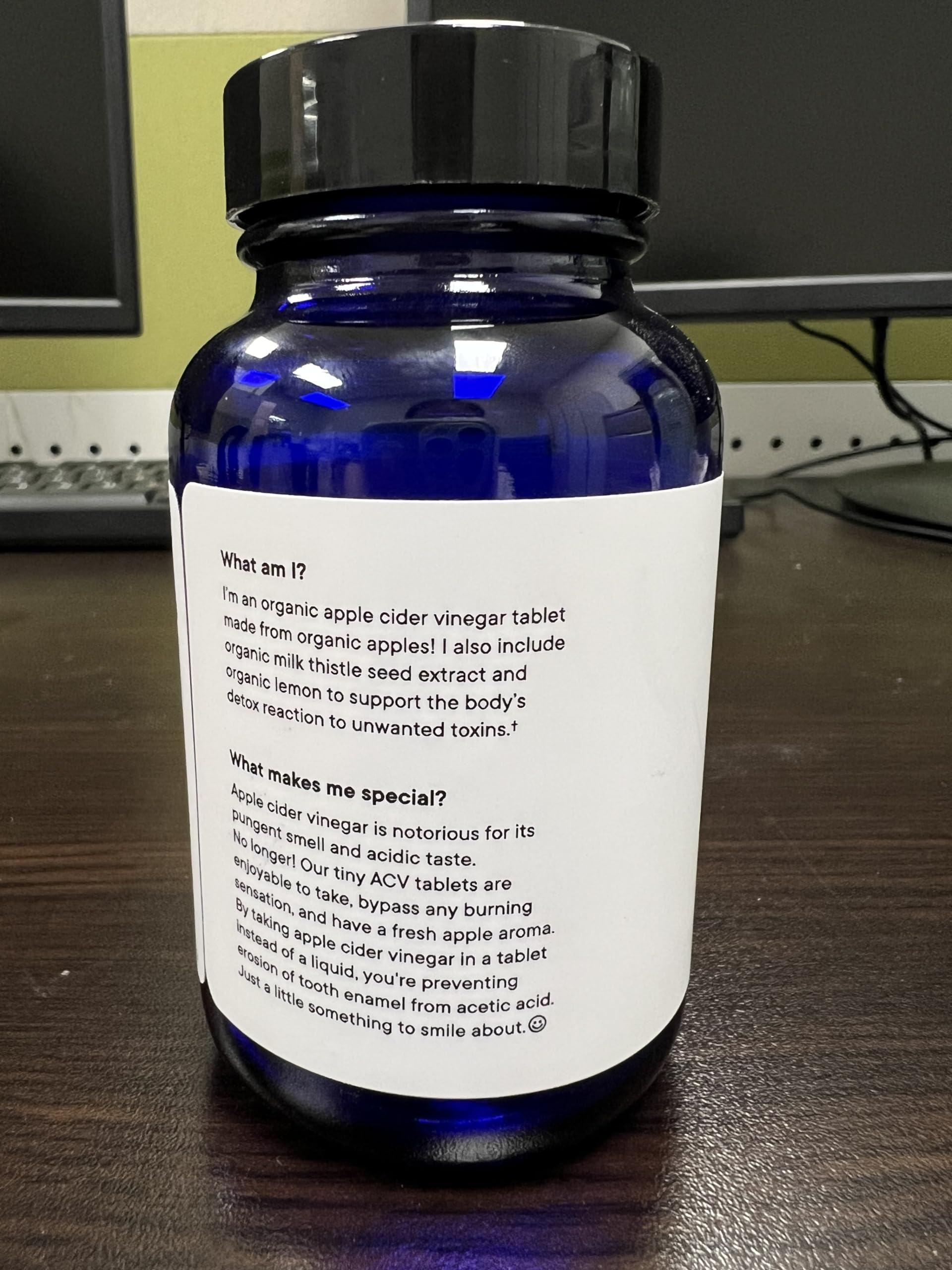 Ora Organic ACV pills 60-count bottle displayed with measuring cup for easy dosing.