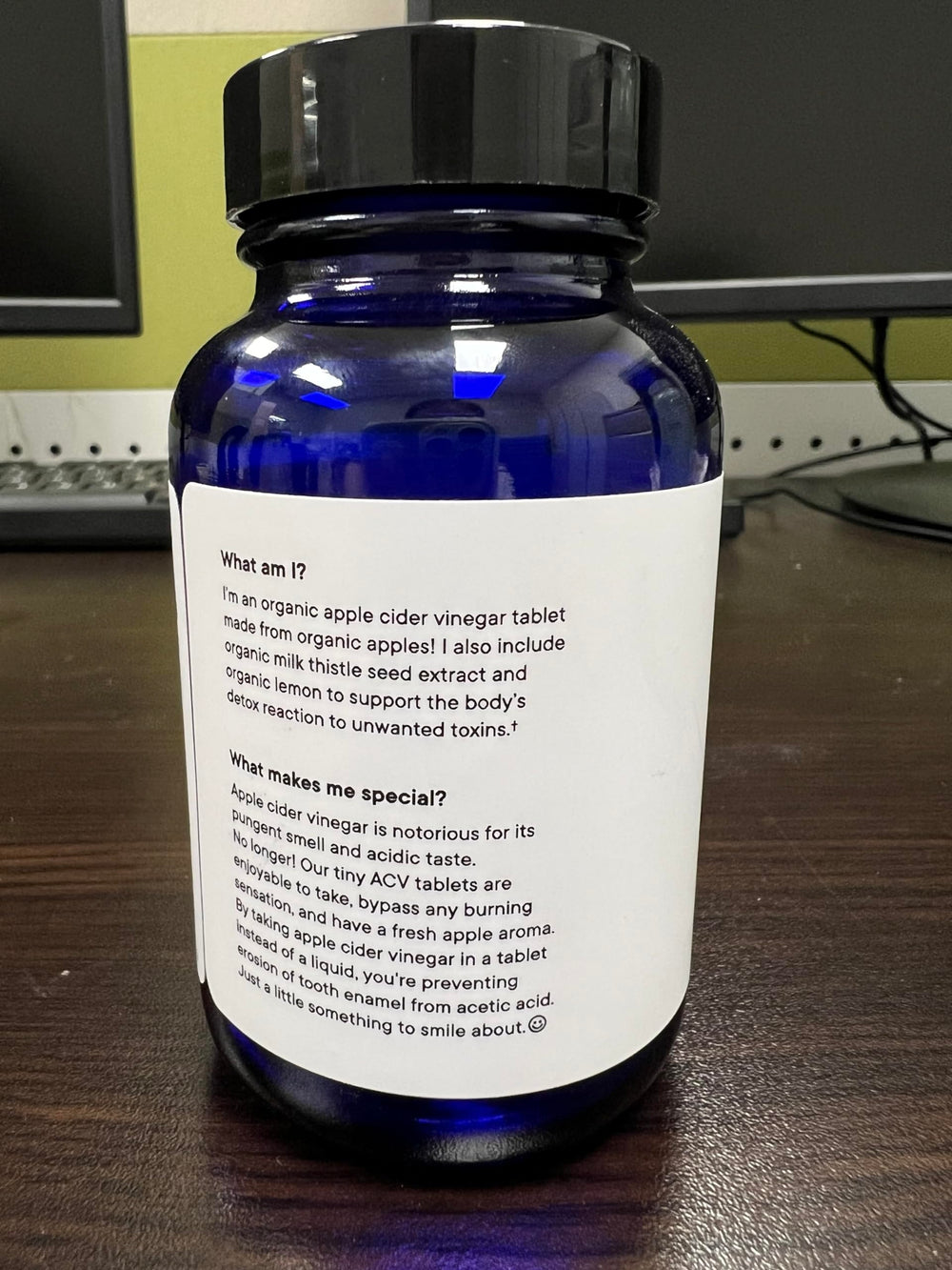 Ora Organic ACV pills 60-count bottle displayed with measuring cup for easy dosing.